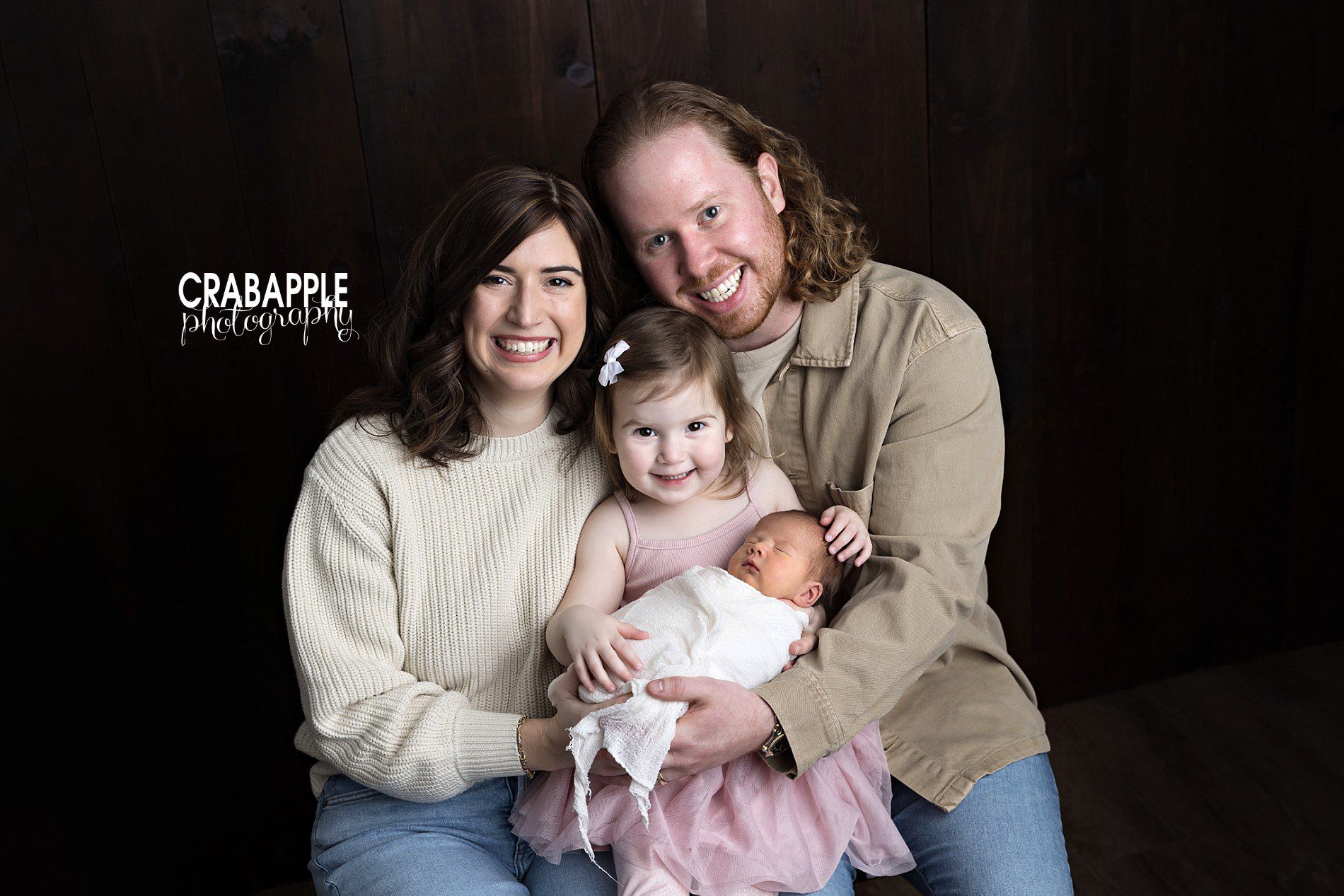 newborn family photos with mom, dad, and toddler sister