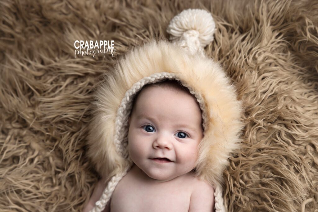 Baby Boy Milestone Portrait Baby boy looking toward camera during neutral studio portrait session in Amesbury