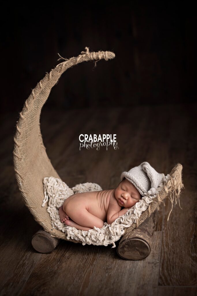 Unique crescent moon newborn photo with sleeping baby – Massachusetts studio photographer