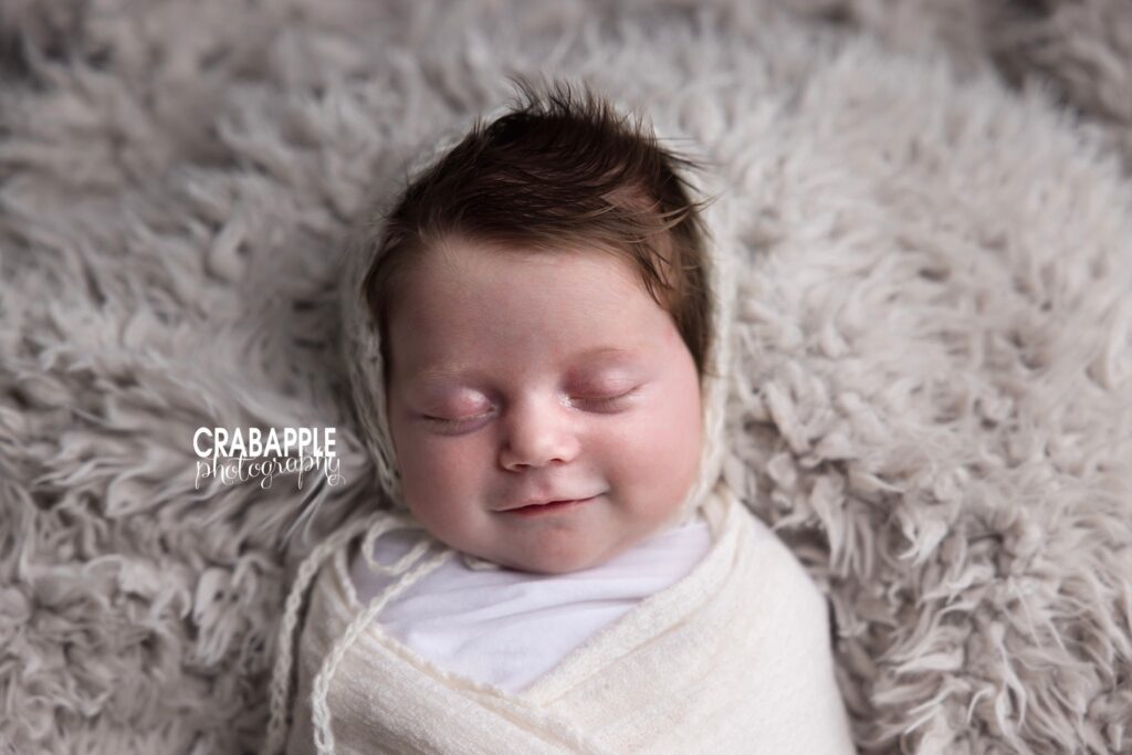 Close-up newborn portrait with thick dark hair from a Massachusetts baby photo studio
