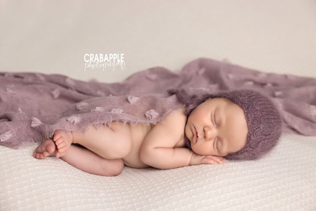 Studio Baby Portrait Newborn baby photographed in a comfortable studio pose with shades of purple