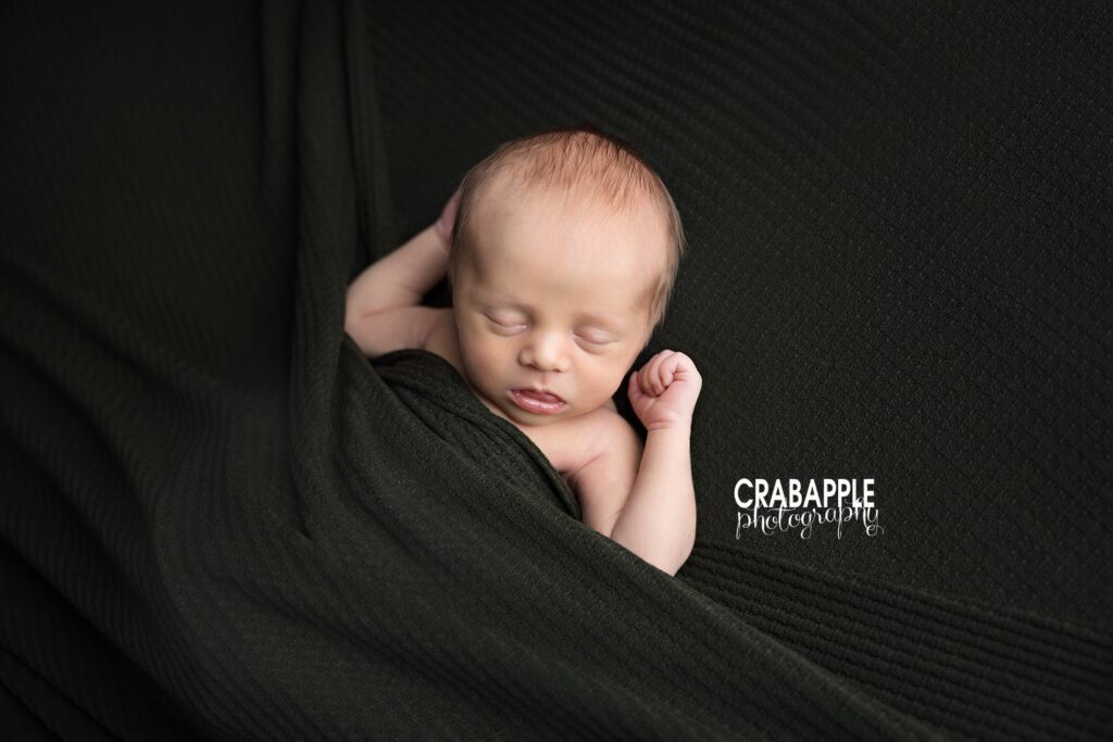 Stretching Newborn Photography Naturally posed newborn stretching during a professional photography session
