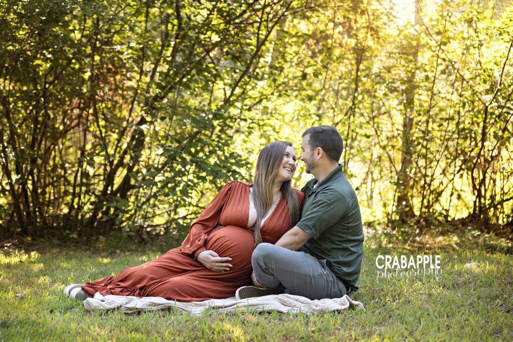 Relaxed outdoor maternity session with couple sitting in golden light – Maternity Photographer Andover MA