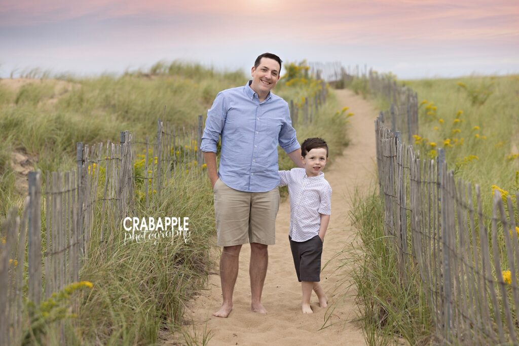 Dad and son walking between beach grass during Crane Beach session
