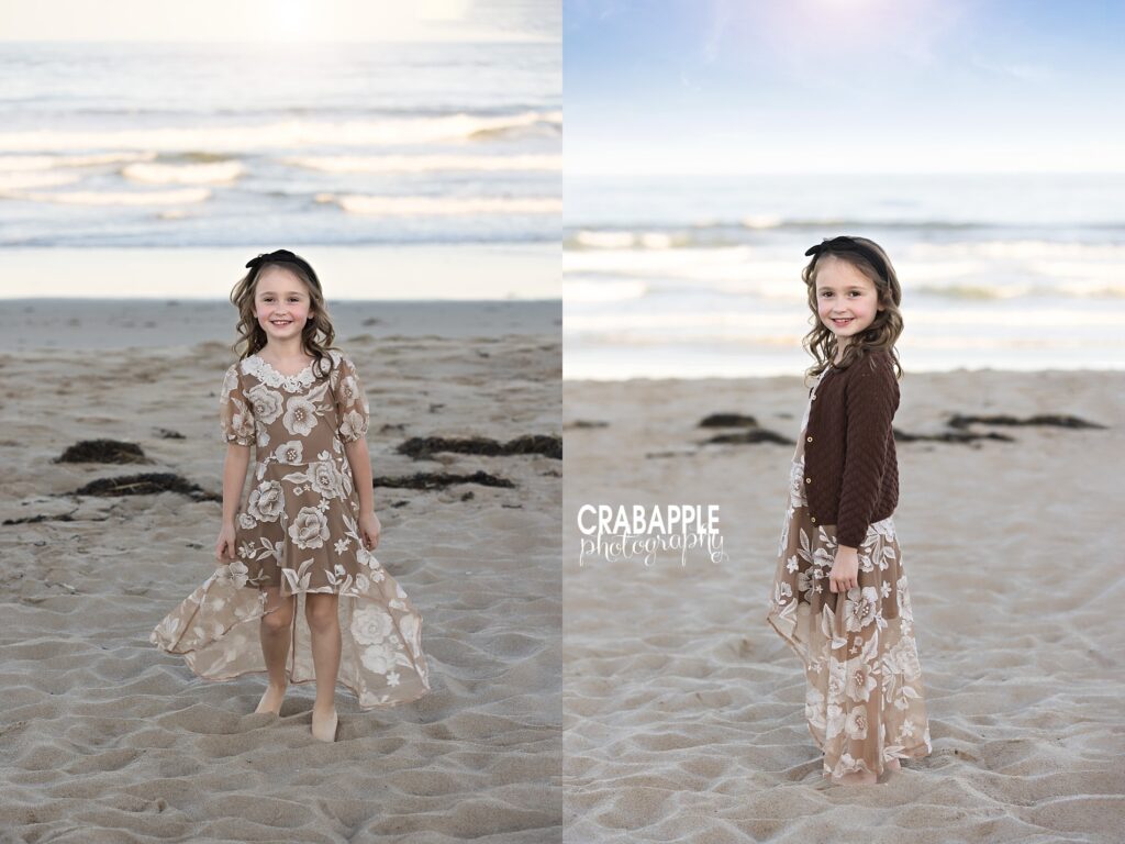 Young girl smiling and playing on the beach in floral dress