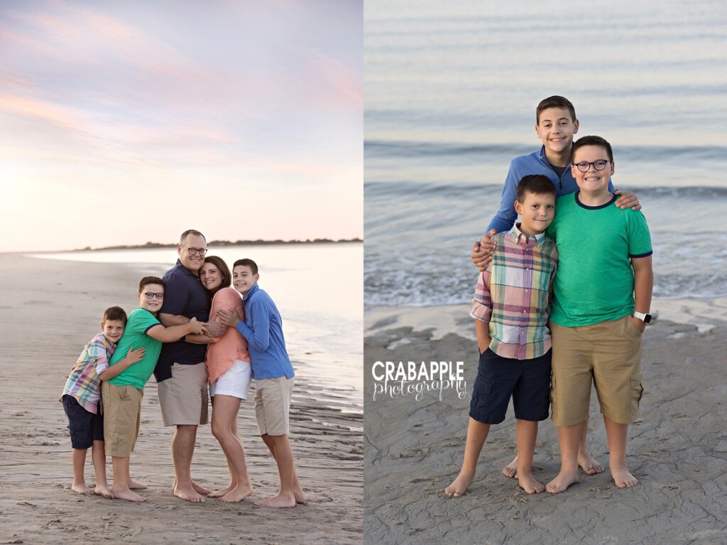 Family of five posing closely with ocean sunset in the background