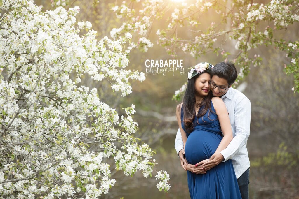 Maternity couple posing under spring blossoms – Pregnancy Photography Studio serving Andover MA