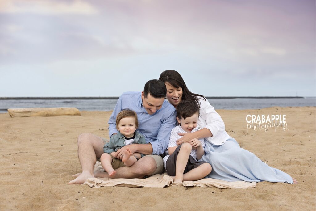 Parents and kids smiling and playing together during natural family beach session near Plum Island in MA
