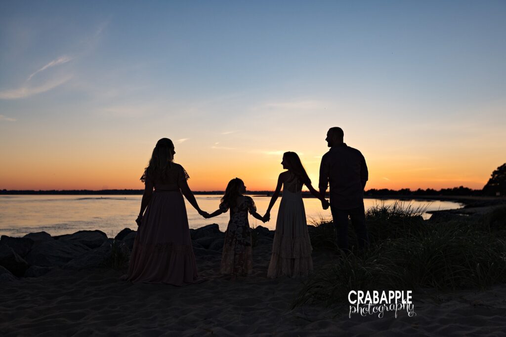 Family silhouettes at sunset beach session near Boston Silhouette of family at the beach during sunset near Boston