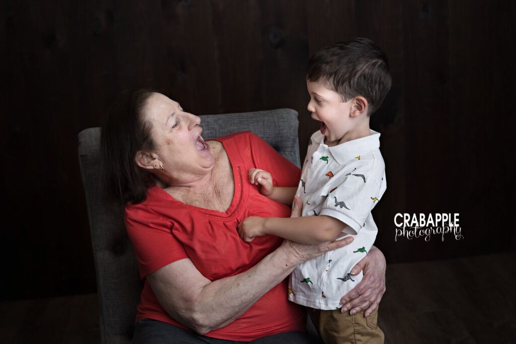 Candid grandparent and grandchild portrait by Andover MA photography studio Grandma and grandson sharing a silly laugh during Andover MA studio session