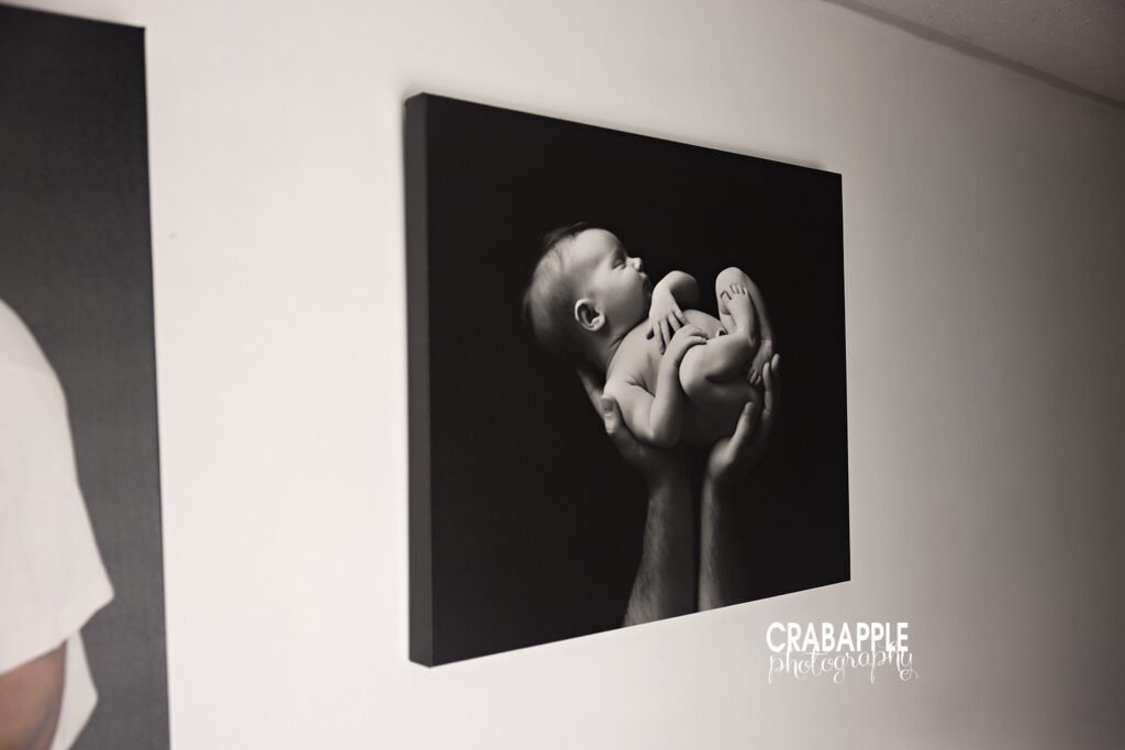 Gallery wrapped canvas of a newborn photo by Boston photographer Newborn portrait printed on a fine art gallery wrapped canvas hung on white wall as part of gallery wall