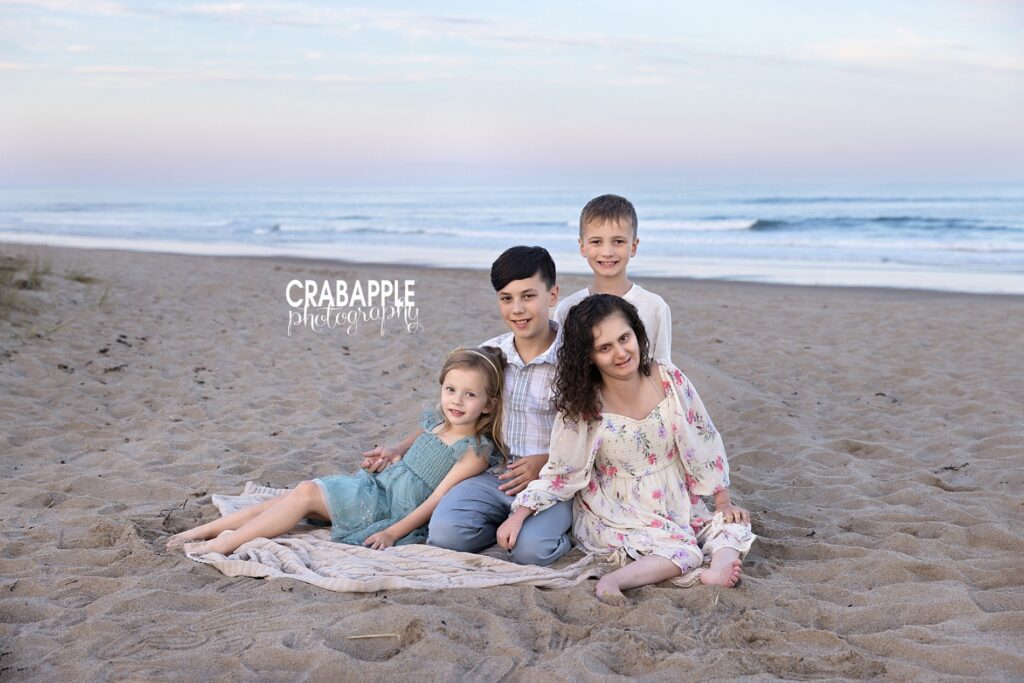 Family group portrait at Salisbury Beach during sunset Four siblings family photo during a relaxed family photo session on Salisbury Beach