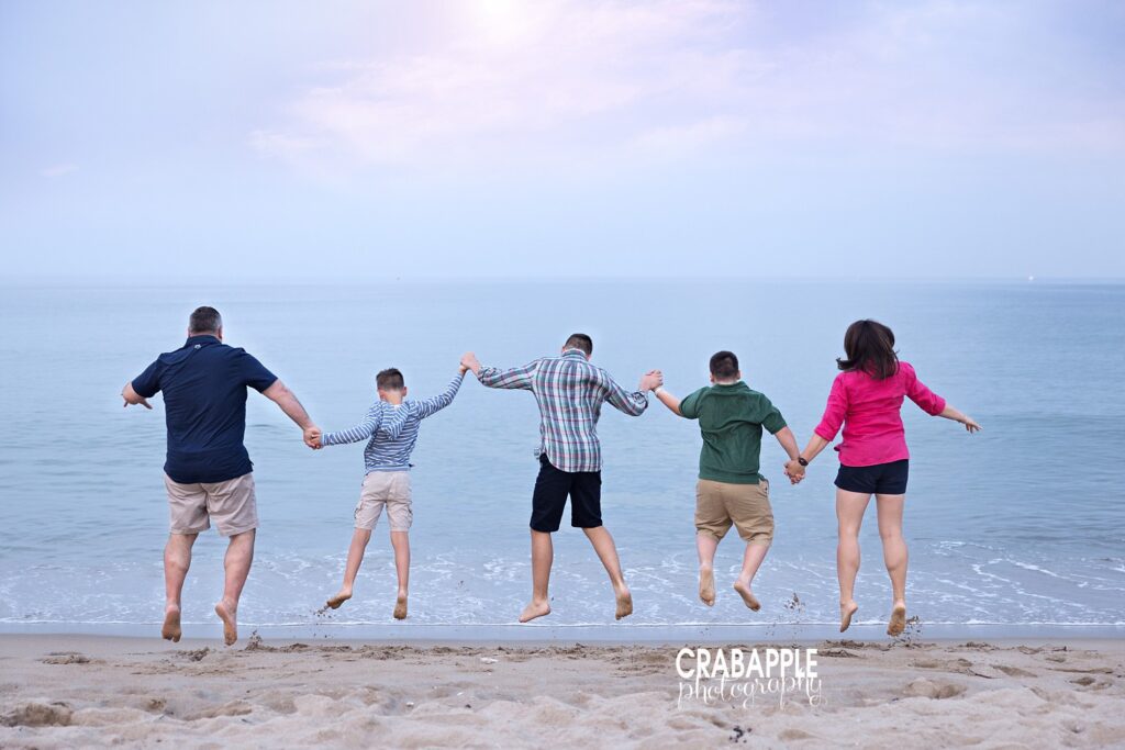 Candid photo of parents with their older boys at Salisbury Beach.