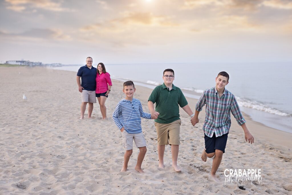 siblings running near the water during family photo session North Shore MA
