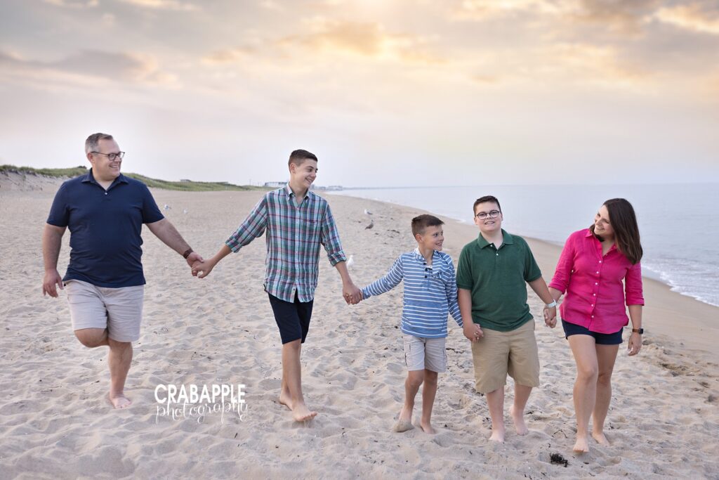 Family of five walking towards the ocean at Salisbury Beach during golden hour.