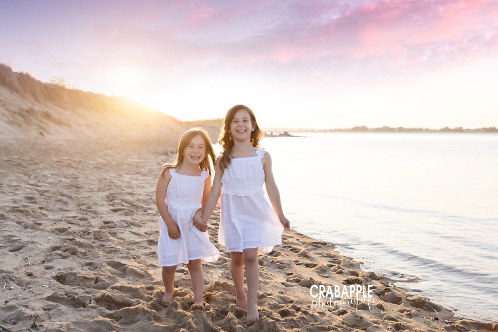 Stunning cotton candy skies during beach mini session photo of two sisters