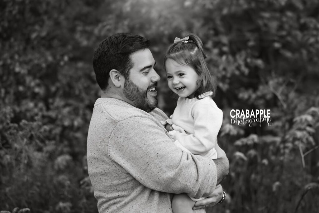 A sweet candid moment between father and daughter captured in family portrait session