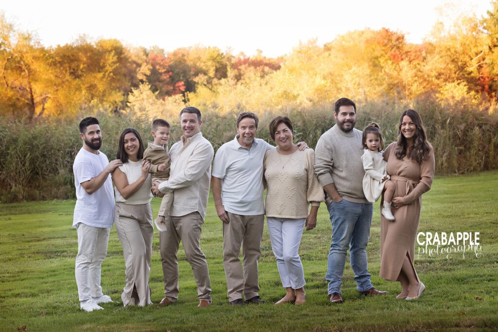 Extended family enjoying fall portraits outdoors in Andover MA