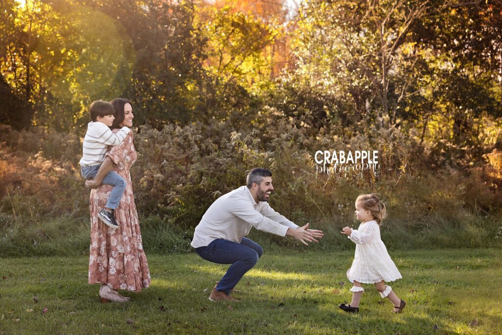 Candid moments in family portraits A loving candid moment captured during a family photo session of a family of four from Wakefield MA, a fun family and children fall portrait session