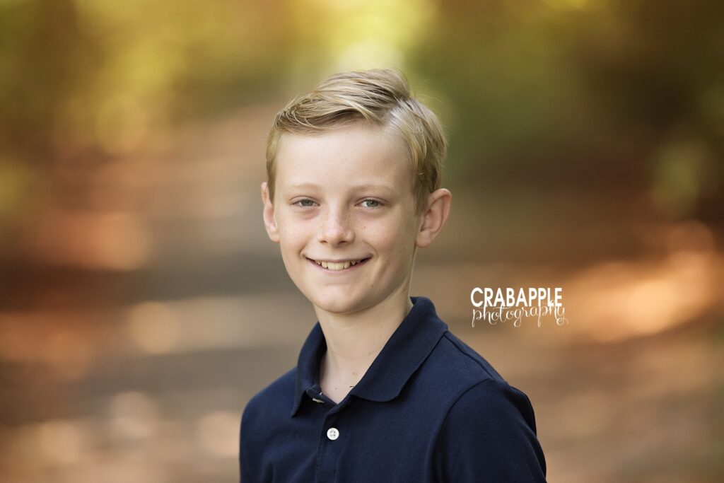 Boy smiling during outdoor autumn portrait session
