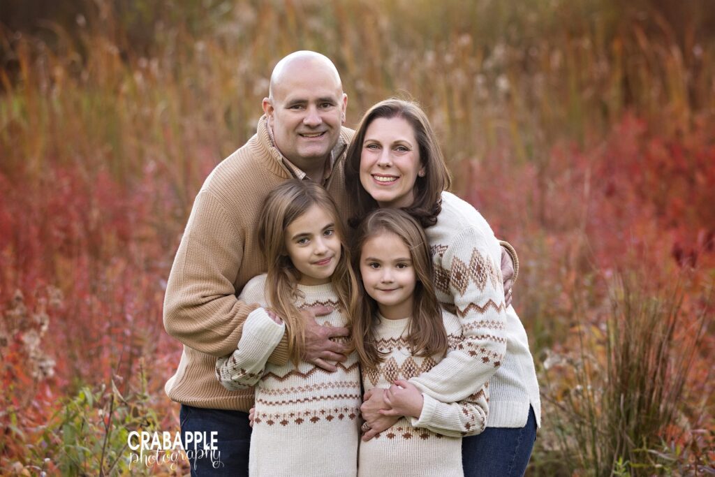 What to wear for Boston fall family photos with layers Parents and children in layered Boston fall family photo outfits for a cozy autumn session