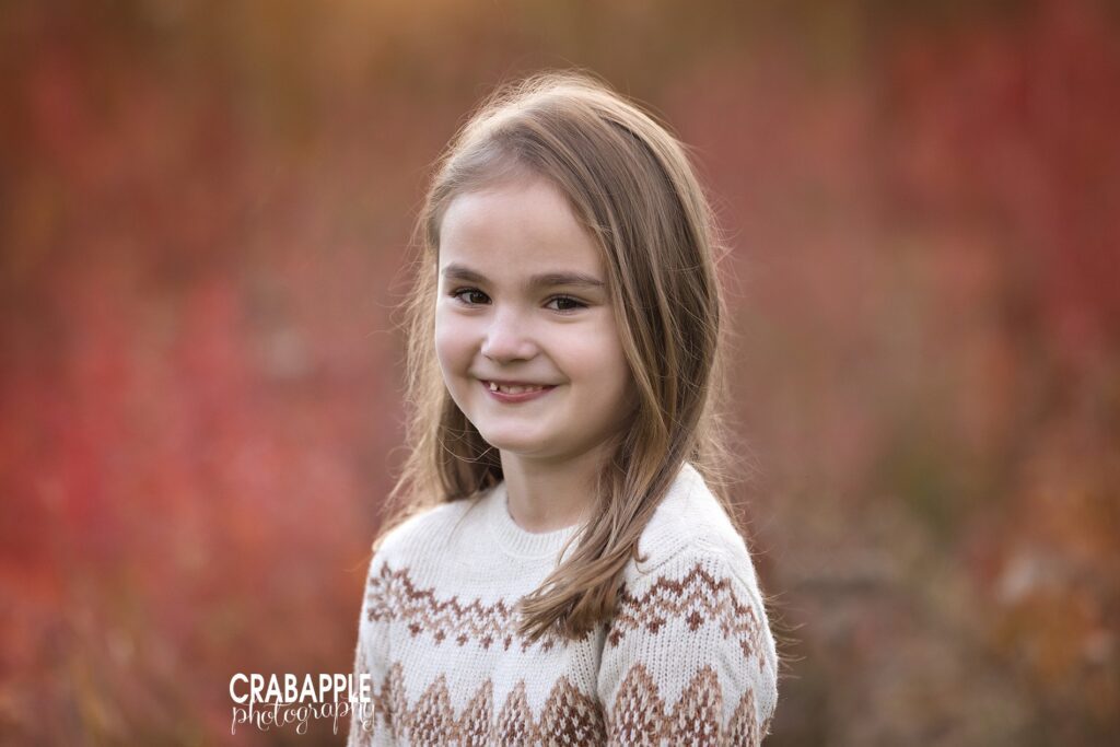 Young girl smiling during outdoor fall portrait session
