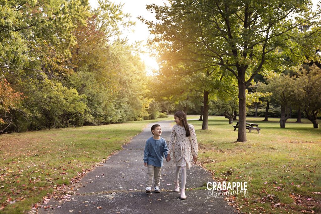 Siblings walking toward the camera during outdoor fall family photos Boston
