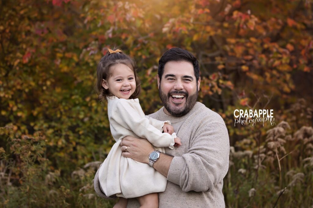 A sweet and joyful portrait of a father and toddler daughter during fall family photoshoot