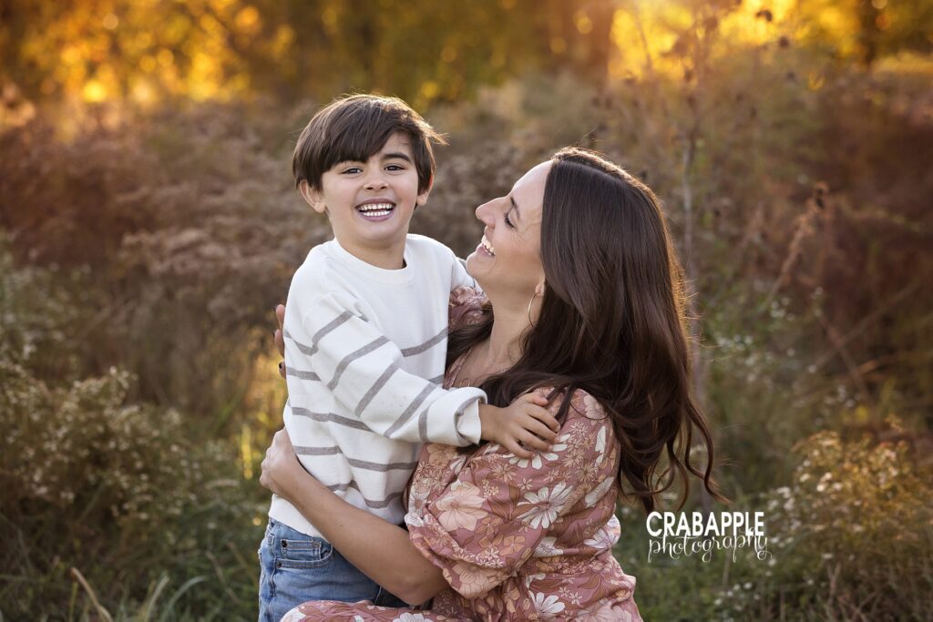 Mom and son pictures Mother and son photo where mom is looking at son and both are smiling during family pictures