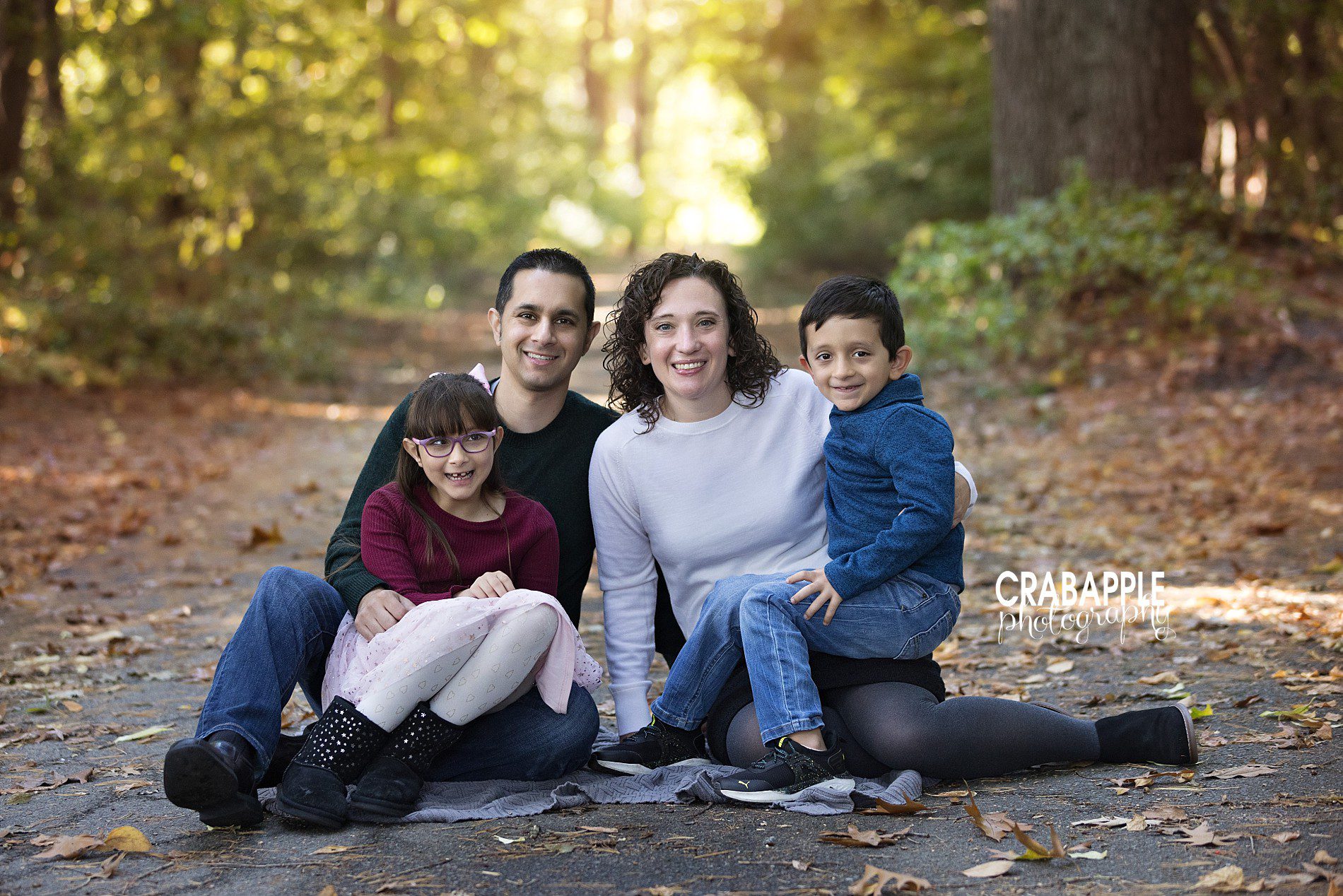 Parents and kids sitting close together for North Shore MA family photography
