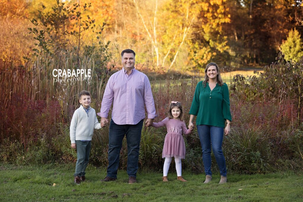 Posed family of four portrait during outdoor fall foliage portrait session near Reading MA