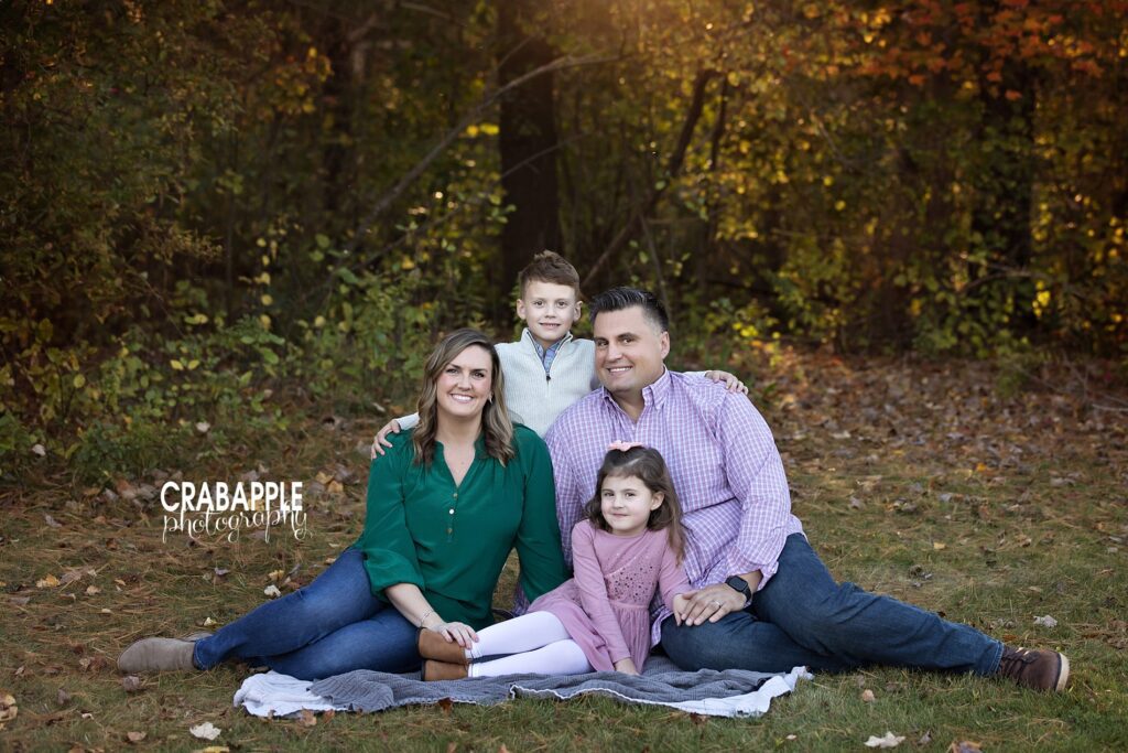Posed portrait of a family of four during their outdoor fall family photo session near Reading MA