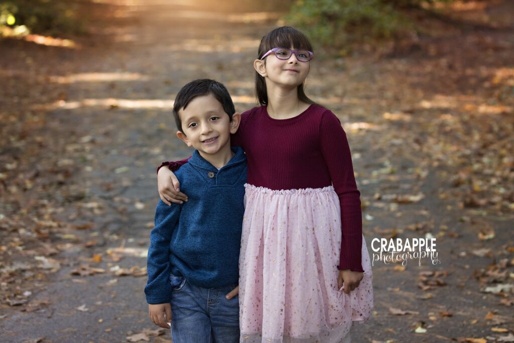Two siblings wearing deep and vibrant jewel tones for their fall portraits