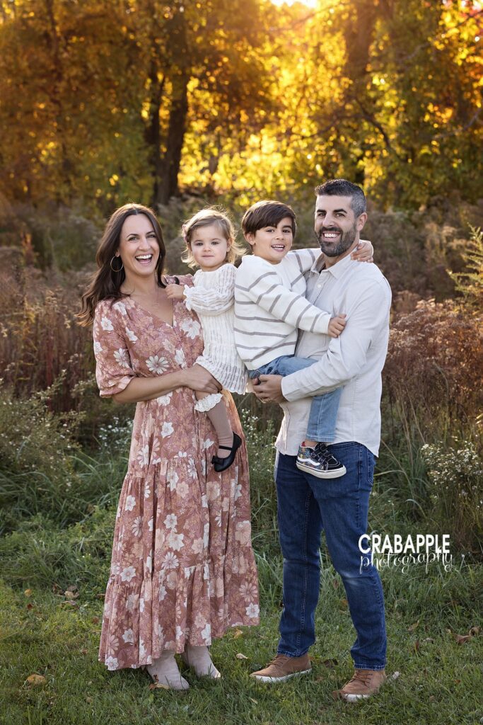 Posed family photo outside Ideas for posing family of four for outdoor fall family portraits near Wakefield MA