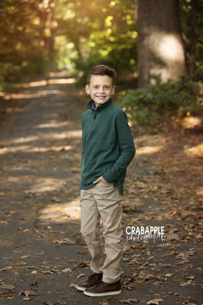 A boy in a deep hunter green top during fall portraits