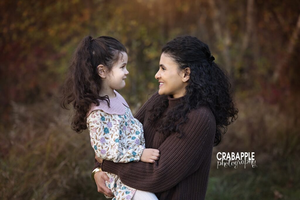 Mom and daughter during fall portraits in Andover MA Mom shares a sweet solo moment with her daughter during fall portraits in Andover