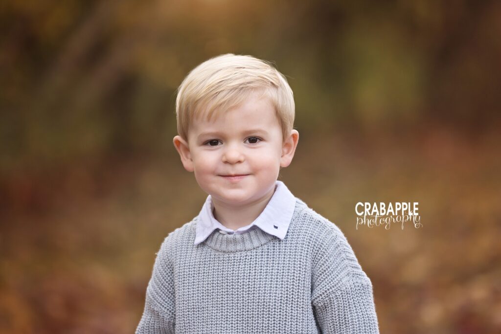 Candid outdoor child photo of toddler boy in gray sweater during Lynnfield MA fall family session
