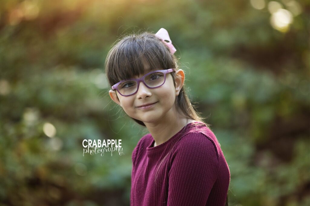 Young girl in a deep wine colored top for her fall family portraits