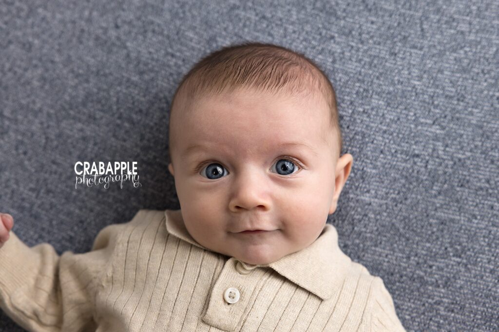 Baby portraits near the North Shore MA Close up portrait of a baby boy with bright blue eyes looking at the camera