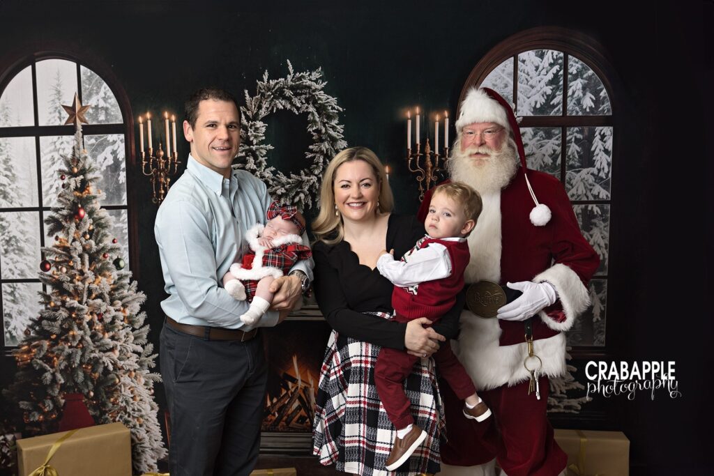 Family of four pose with Santa Claus