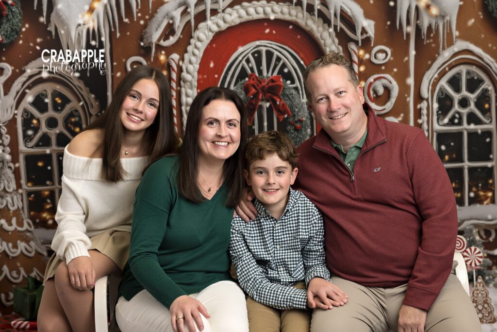 Mom, dad, son, and daughter posing together during elegant holiday mini session.
