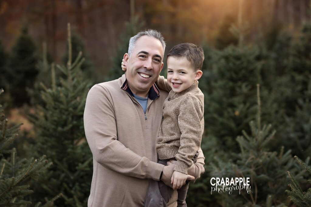 Father and son in neutral beige outfits pose for family holiday photos