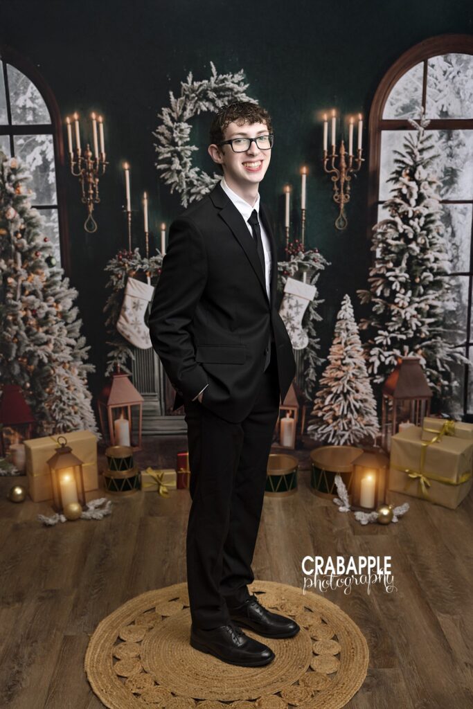 A portrait of a teenage boy in a suit during family Christmas portraits