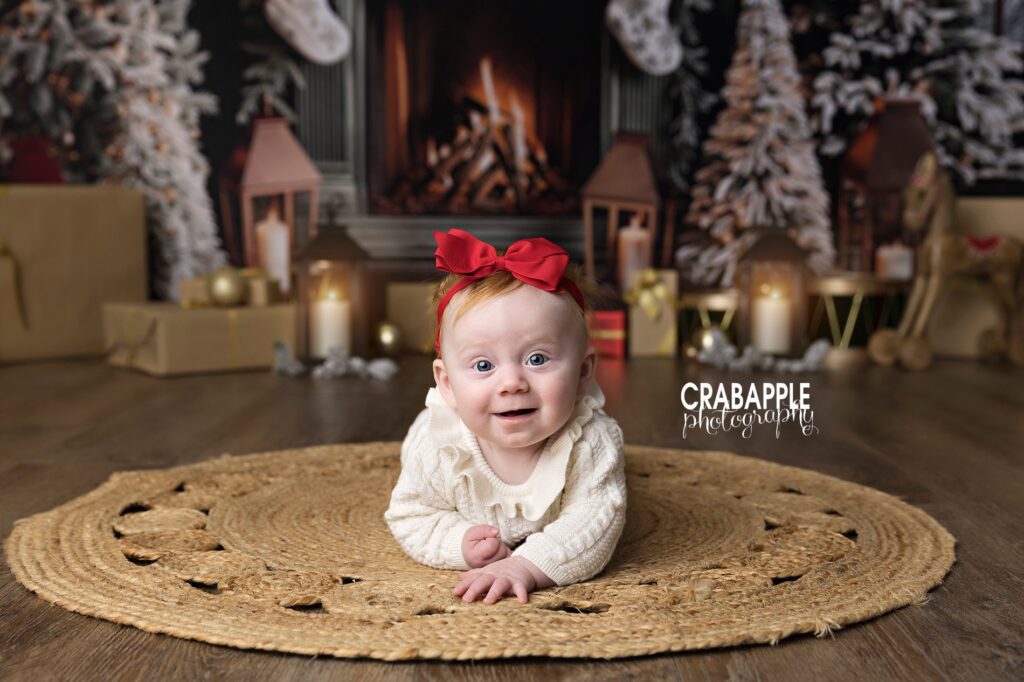Christmas photos for babies under 3 months | Cozy tummy time baby portrait Infant on tummy time during Christmas photos for babies under 3 months, on cozy Christmas set