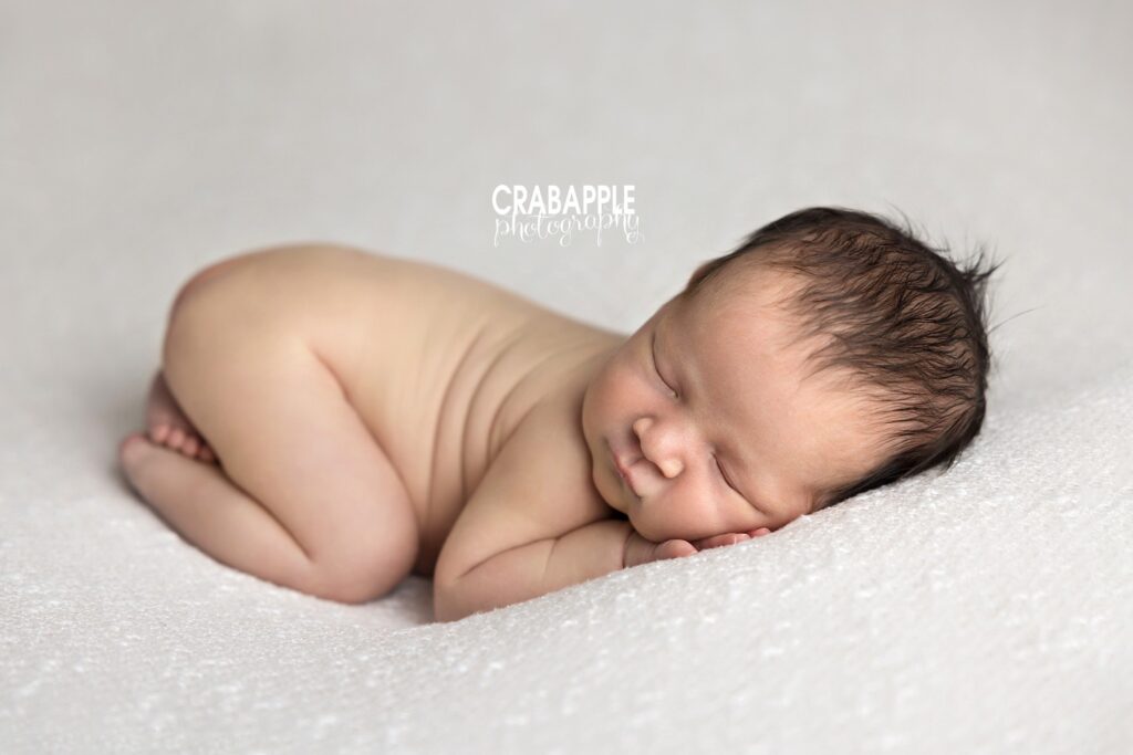 Simple and timeless newborn portrait with soft neutral tones in Boston studio.
