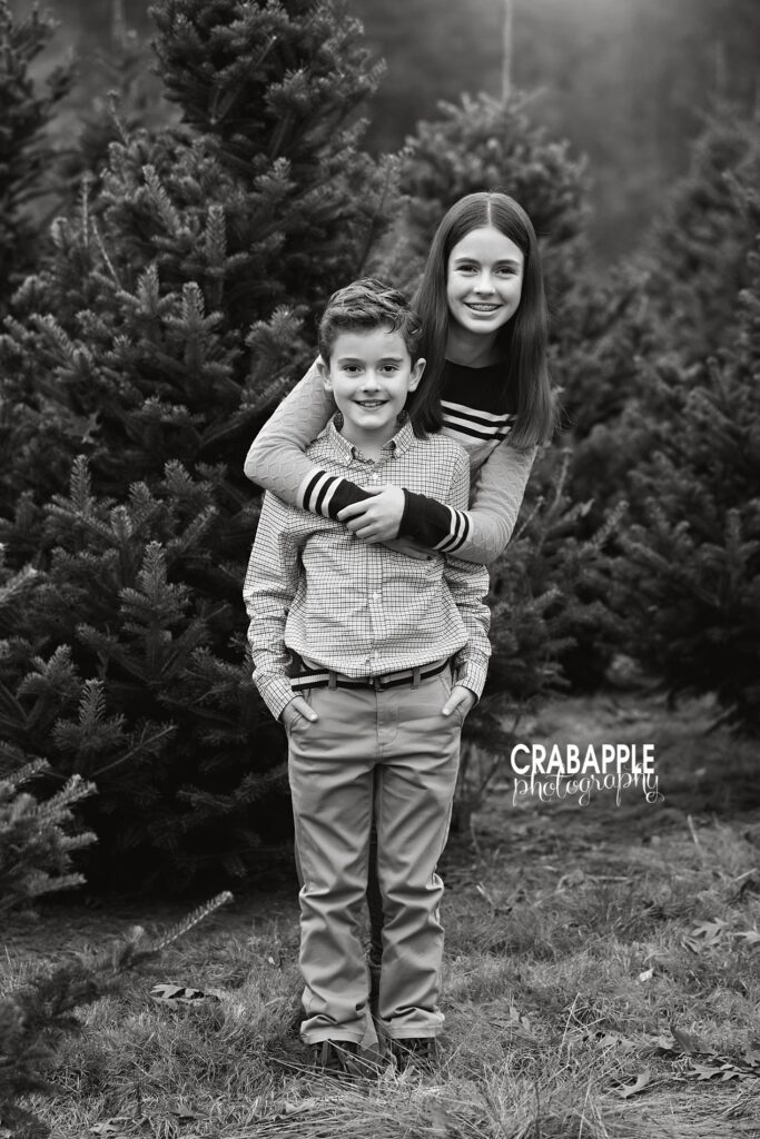 Sweet sibling hug captured during tree farm mini session
