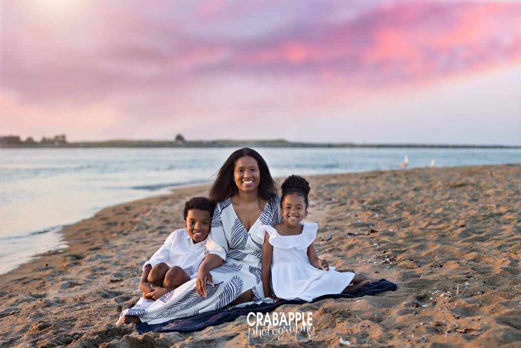 Family smiling together during golden hour at a North Shore beach in Massachusetts
