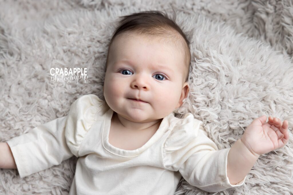 Baby girl in cream outfit during 3-month baby milestone session Andover MA
