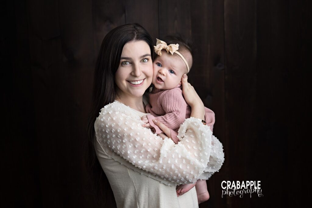 3-month baby milestone photos of mom holding baby girl during Andover MA studio session
