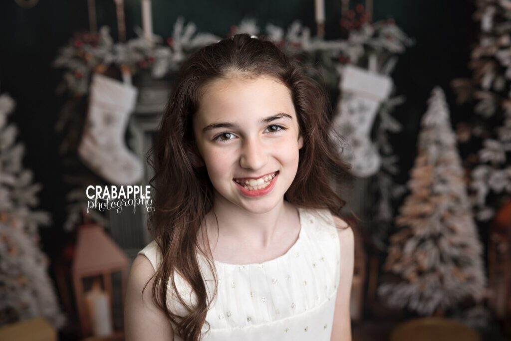 Close up studio Christmas portrait of young girl with soft festive lighting